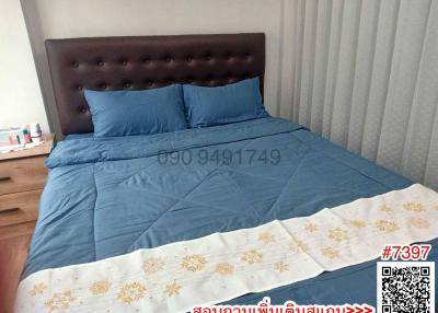Cozy bedroom with upholstered headboard and blue bedding