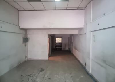 Spacious interior of an empty building space with tiled floors and white walls