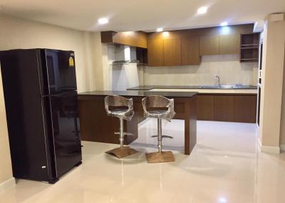 Modern kitchen with breakfast bar and stainless steel appliances