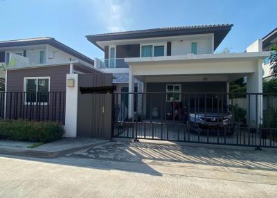 Contemporary two-story house with a gated driveway