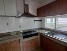 Modern kitchen with wood cabinets and stainless steel appliances