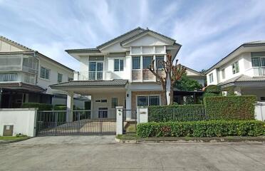 Exterior view of a two-story residential house with a clear sky