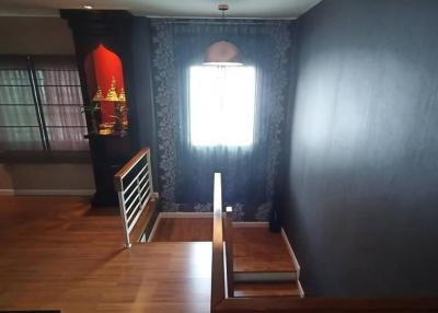 Cozy living room with elegant dark wallpapers and hardwood flooring