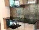Modern kitchen with stainless steel backsplash and built-in appliances