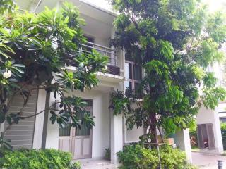 Peaceful external view of a residential building surrounded by greenery