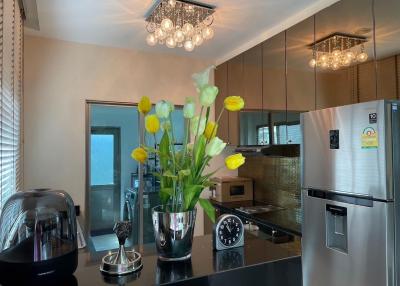 Modern kitchen with stainless steel appliances and elegant lighting