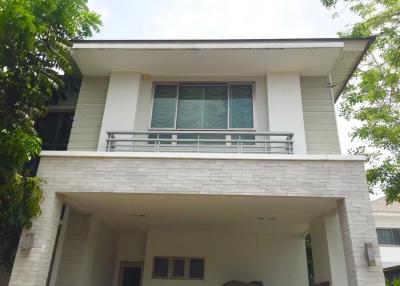 Front view of a modern two-story house with a white exterior
