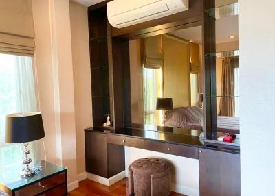 Elegantly designed bedroom with large mirror and modern furnishings
