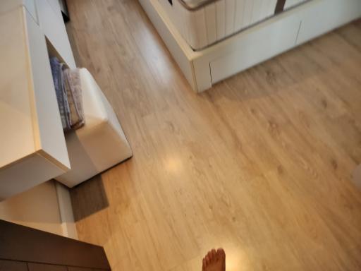 Partial view of a room with wooden flooring and modern furniture