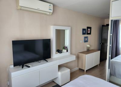 Modern bedroom with TV and air conditioning unit