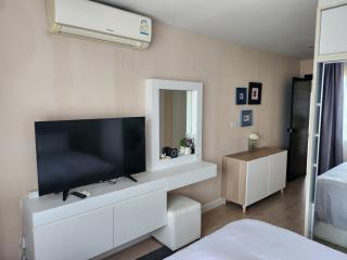 Modern bedroom with TV and air conditioning unit
