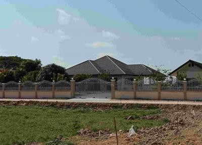 Spacious residential property with fenced yard and clear blue skies