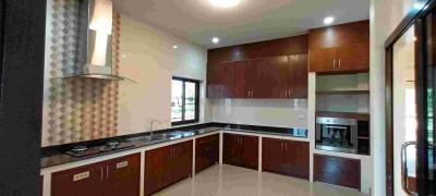 Modern kitchen interior with wooden cabinets and stainless steel appliances