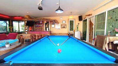 Spacious game room with pool table and bar area