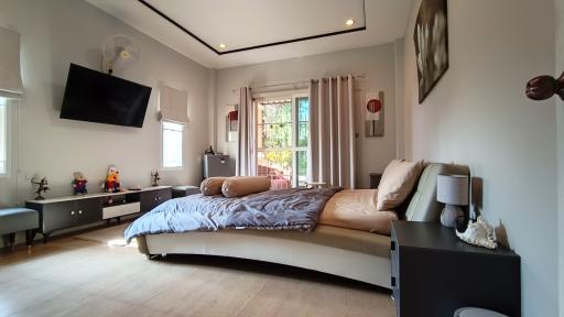 Spacious modern bedroom with natural light and stylish decor