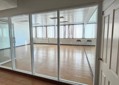 Spacious empty room with large windows and reflective floor