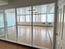 Spacious empty room with large windows and reflective floor