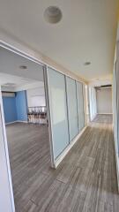 Modern hallway with large glass doors and wooden flooring