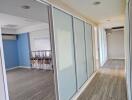 Modern hallway with large glass doors and wooden flooring