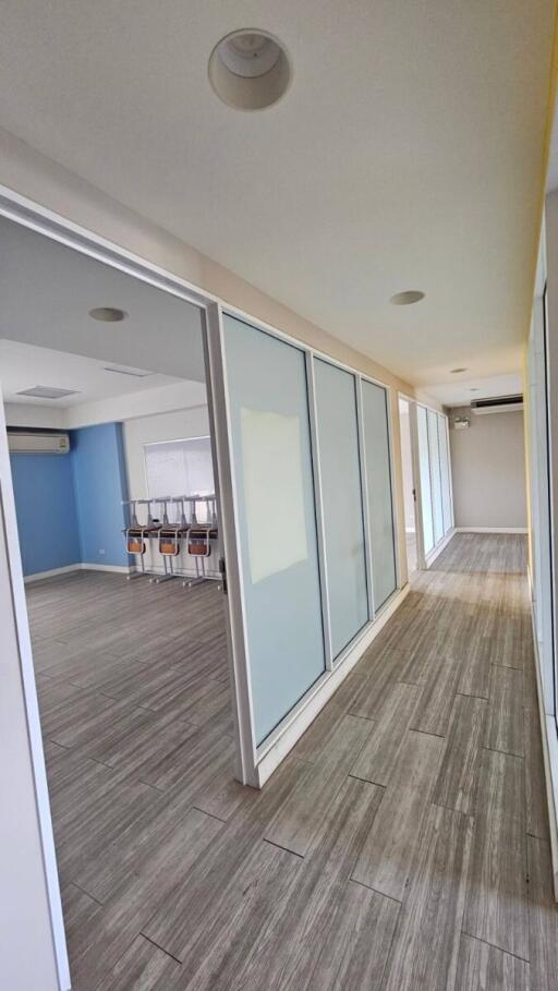 Modern hallway with large glass doors and wooden flooring