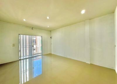 Spacious and brightly lit empty living room with glossy floor