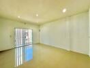 Spacious and brightly lit empty living room with glossy floor