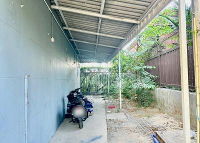 Covered exterior pathway with a parked motorcycle