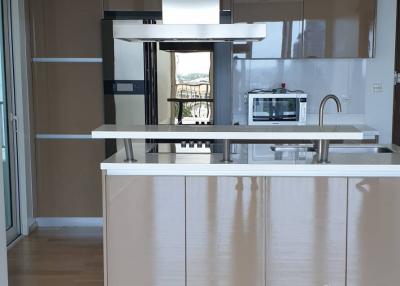 Modern kitchen with white cabinetry and stainless steel appliances