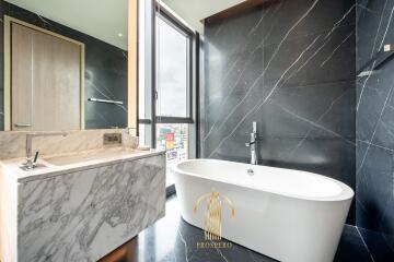 Modern bathroom with a freestanding tub and marble finishes