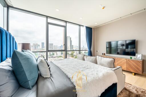 Modern bedroom with large windows and city view