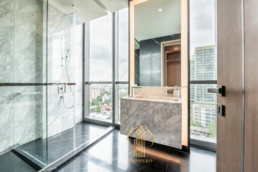 Modern bathroom with large windows and marble tiles