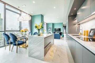 Modern kitchen with marble flooring and a view of the living room area