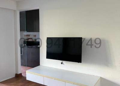 Modern living room interior with mounted television and white entertainment unit