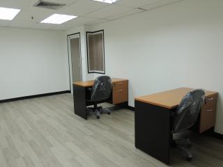 Spacious office area with modern desks and bright interior
