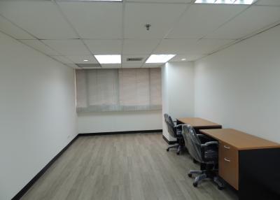 Spacious unfurnished office room with large windows and ample natural light