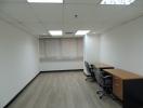 Spacious unfurnished office room with large windows and ample natural light