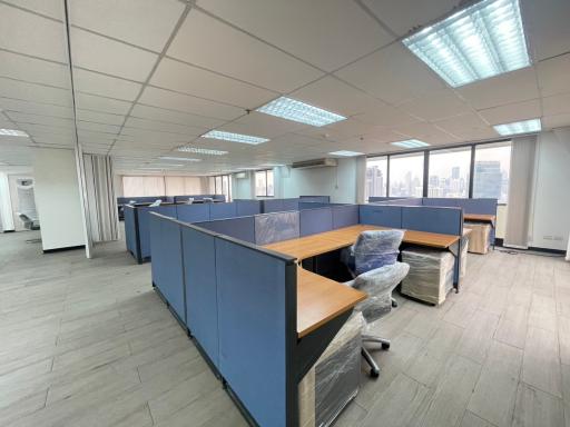 Spacious office area with cubicles and natural lighting