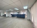 Spacious open-plan office interior with partition panels and large windows