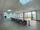 Spacious conference room with large windows and city view