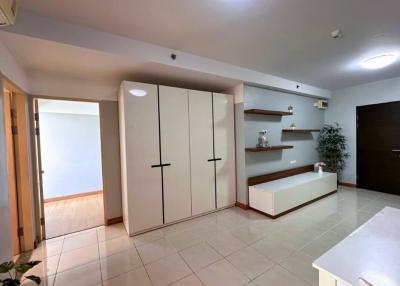 Spacious building interior with large wardrobe and tiled flooring