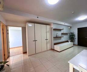 Spacious building interior with large wardrobe and tiled flooring