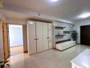 Spacious building interior with large wardrobe and tiled flooring