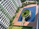 Aerial view of condominium amenities including a swimming pool and garden