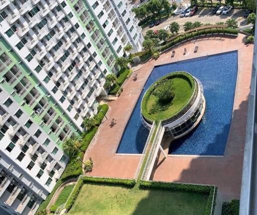 Aerial view of condominium amenities including a swimming pool and garden