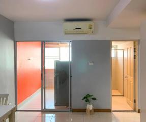 Bright living room with sliding glass door and air conditioning