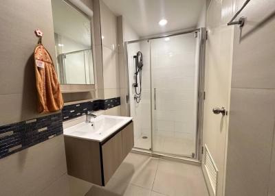 Modern bathroom interior with glass shower and vanity
