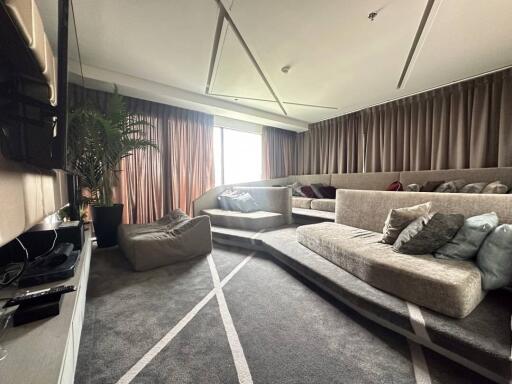 Spacious and modern living room with large sofa and natural light