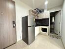 Modern kitchen with stainless steel appliances and tiled flooring