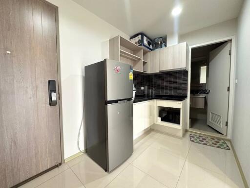 Modern kitchen with stainless steel appliances and tiled flooring