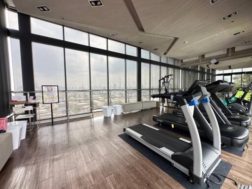 Modern high-rise gym with panoramic city views